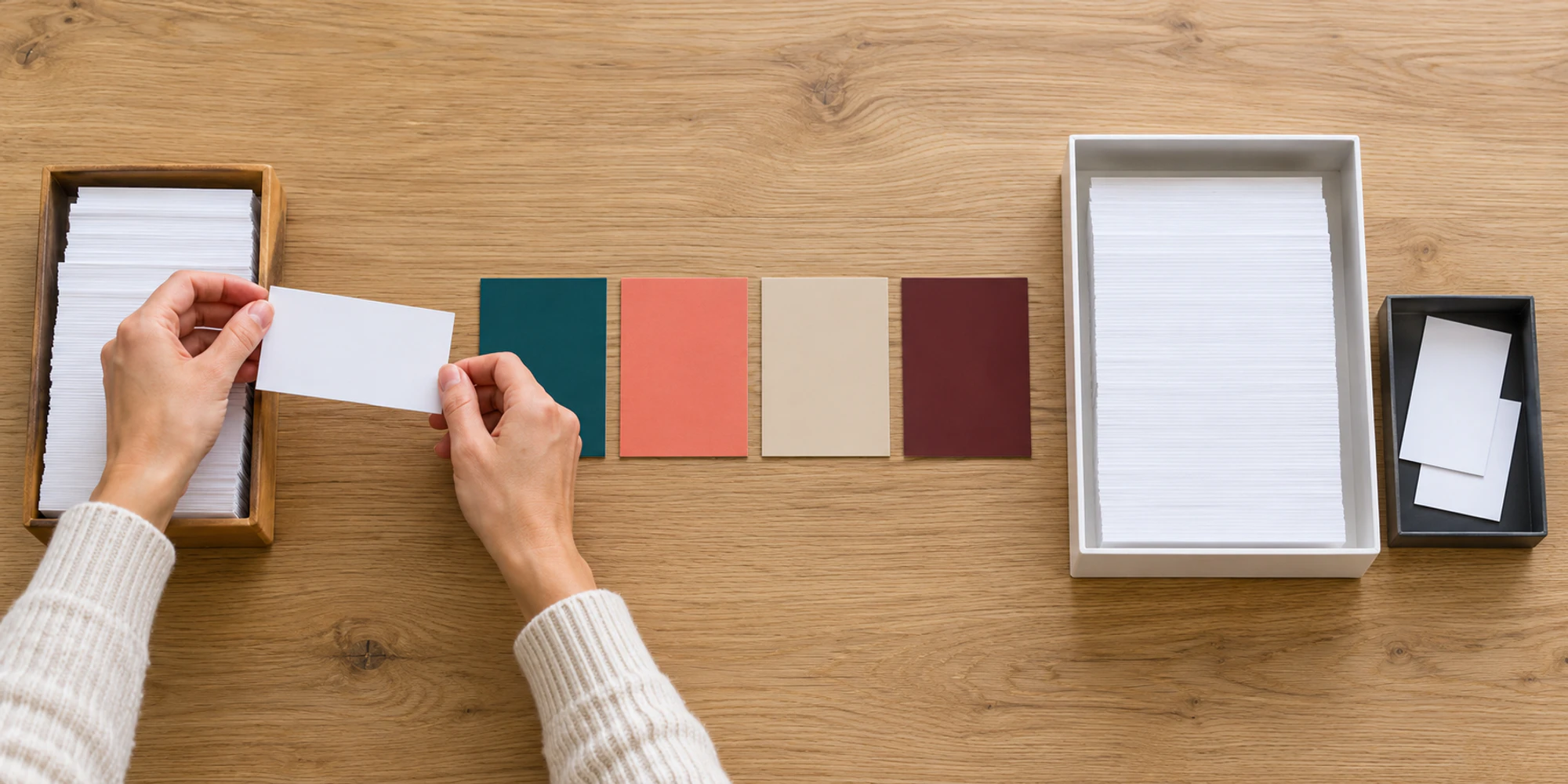 Hands move a blank contact card from a source stack past field cards to review and exception trays