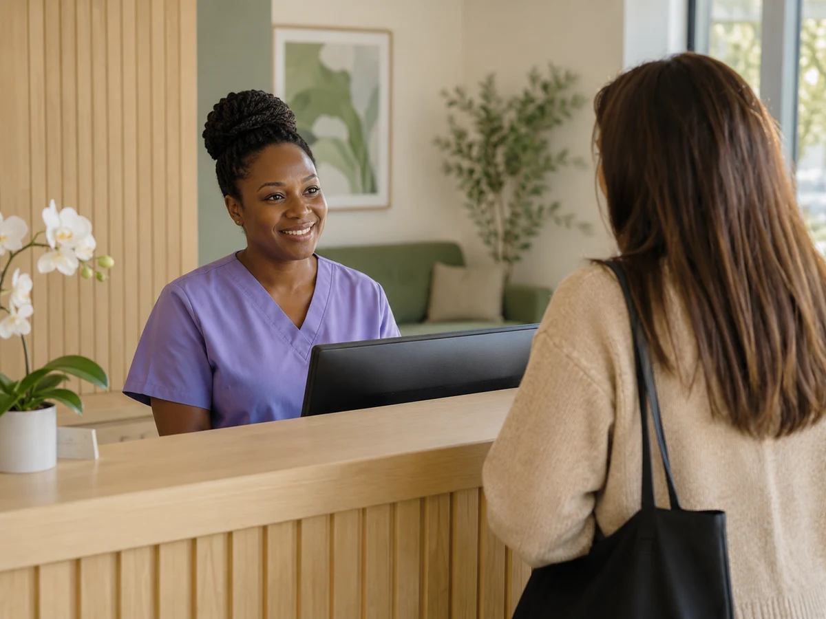 Clinic receptionist helping a patient with an appointment
